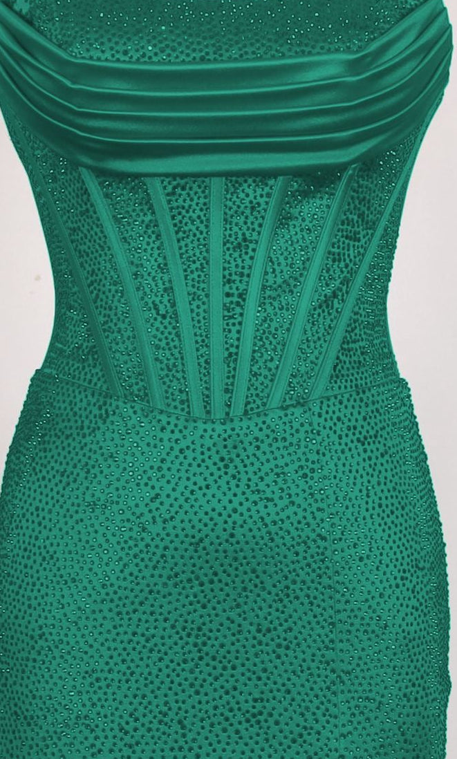 A close-up of the PromGirl Exclusive 250217, a long emerald green strapless prom dress with a structured, vertically boned bodice, sparkling embellishments, and a chic lace-up back.